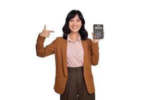 MwSt Tag Konzept. asiatisch Frau zuversichtlich lächelnd halten Taschenrechner und Finger Punkt Gerät, Porträt glücklich asiatisch weiblich isoliert auf Weiß Hintergrund, Konto und Finanzen Zählen Einkommen foto