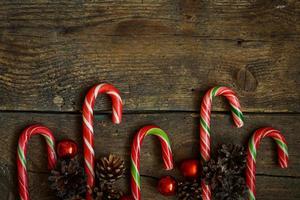 Weihnachten Rand mit Zapfen, Weihnachten Dekorationen und Süßigkeiten Stock auf hölzern Bretter foto