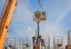 Bauarbeiter, die auf hohem Niveau an Gerüsten arbeiten foto