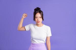 Porträt von ein schön asiatisch Frau posieren auf ein lila Hintergrund foto