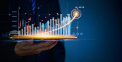 Geschäftsmann mit Tablette online Analyse Wachstum Graph Lager Markt Investitionen Mittel finanziell Daten auf virtuell Schnittstelle Ziel Diagramm. intelligent Technologie Geschäft Lösung Konzept. foto