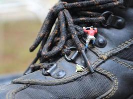 Miniatur Zahl von ein Bergsteiger Klettern im draussen Schuhe. foto