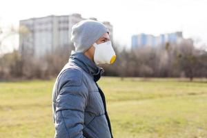 ein Mann tragen ein Maske auf das Straße. Schutz gegen Virus und Griff foto