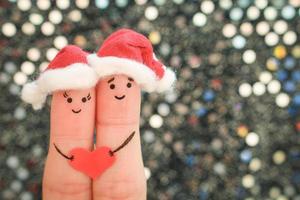 Finger Kunst von Paar feiert Weihnachten im Neu Jahr Hüte. getönt Bild. foto