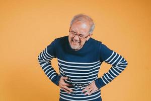 asiatisch Senior Mann Gefühl Magenschmerzen. älter reifen männlich berühren Bauch. Darm Problem Gesundheit Pflege und medizinisch Versicherung Konzept. foto