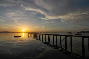 Landschaft Betrachtung von hölzern Brücke auf Meer im früh Morgen beim Fischer Seebrücke jelutong foto