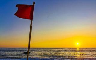 rot Flagge Schwimmen verboten hoch Wellen mit Sonnenuntergang im Mexiko. foto