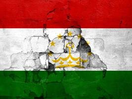 Erdbeben im Tadschikistan, Flagge Tadschikistan auf ein Mauer mit Risse von ein Erdbeben foto