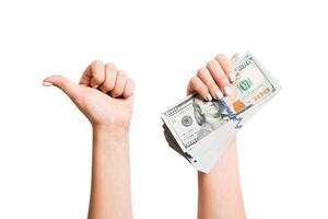 isoliert Bild von Dollar im einer Hand und zeigen Daumen oben Geste mit Ein weiterer Hand. oben Aussicht von Geschäft Konzept foto