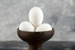 Schüssel weiße Eier auf einem Marmorhintergrund foto