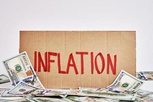 Welt Inflation Konzept. Karton mit Wort Inflation und USD Banknoten foto