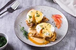 köstlich hausgemacht Frühstück mit Waffeln, Speck und Eier Benedikt auf ein Platte. foto