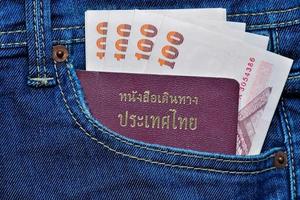 Thailand Reisepass und Geld im Jeans Tasche foto