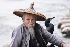 xing, China - - März 02, 2016-Kormoran Fischer sitzt auf das uralt Bambus Rafting - - das li Fluss, xing, China. foto