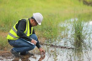 Umwelt Ingenieure Arbeit beim Wasser Quelle zu prüfen zum Verunreinigungen im Wasser Quellen und Analysieren Wasser Prüfung Ergebnisse zum wiederverwenden.welt Umgebung Tag Konzept. foto