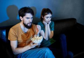 Aufpassen Fernseher Show im das Abend auf das Couch und Mann mit Frau Familie freunde foto