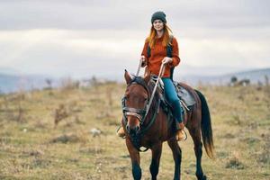 Frau Wanderer Fahrten ein Pferd auf Natur im das Berge foto