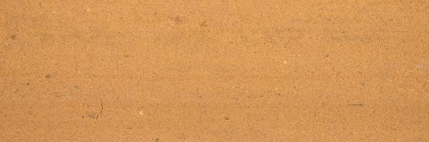 Hintergrundtextur von der losen Oberfläche des Sand- und Erdbodens foto