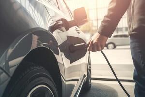 Hand halten elektrisch Auto Ladegerät. elektrisch Fahrzeug ev Laden Bahnhof und Ladegerät. Mensch Hand ist halten elektrisch Auto Laden verbinden zu elektrisch Wagen. generativ ai. foto