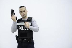 Porträt von Polizei halt Gewehr im Hand auf Weiß Hintergrund, hübsch asiatisch Polizist foto