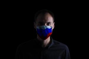 Mann tragen Maske mit Russland Flagge covid-19 foto