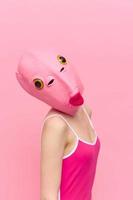 modern Halloween Kostüm im ein Silikon Maske im das gestalten von ein Rosa Fisch Kopf im ein sexy Kostüm. das Konzept von ein verrückt aussehen foto