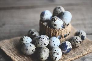 Wachtel Eier auf Korb, frisch Wachtel Eier auf hölzern Tabelle Hintergrund, roh Eier mit schälen Ei Schale foto