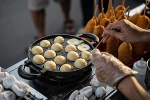 Essen Anbieter Herstellung Takoyaki, ein köstlich Straße Essen Snack beim das jogokariyan Ramadhan Markt foto