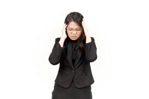 Leiden Kopfschmerzen von schön asiatisch Frau tragen schwarz Blazer isoliert auf Weiß Hintergrund foto