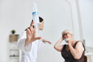 Alten Frau beim das Arzt geplanter Termin Impfung Krankenhaus foto