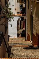 eng Straßen im das alt Stadt, Dorf von Benidorm, Spanien auf ein warm Sommer- Tag foto