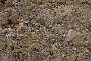 interessant Beige Mauer Hintergrund mit grau Steine im Nahansicht foto