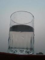 Glas von klar kalt Wasser ist Hälfte voll foto