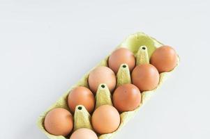Eier von Ei Tablett isoliert auf Weiß Hintergrund. Eier geschützt im ein Licht Papier Recycling Tablett foto