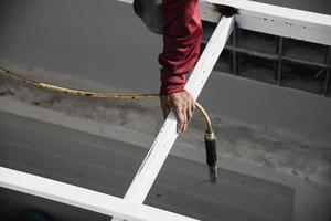 vor Ort Konstruktion Arbeiter mit Stahl Dach Struktur Installation, Wohn Gebäude Auftragnehmer Job foto