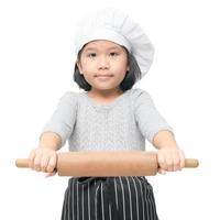 süß asiatisch Mädchen Koch halten rollen Stift foto