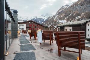 Bänke im Vorderseite von luxuriös Hotels mit schweizerisch Alpen im Hintergrund foto