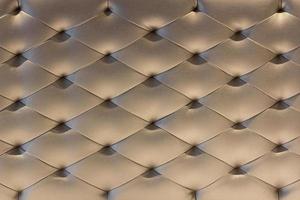 Muster von Gold Leder Polster Sofa Hintergrund. Luxus Dekoration Sofa foto