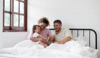 wenig Mädchen Vater lesen Geschichten zu Kinder Vor gehen zu Bett zu entspannen und Schlaf solide bis um das Morgen. foto