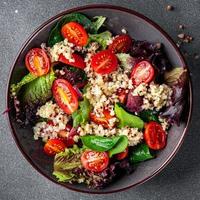 Salat Andenhirse, Tomate, Grün Grüner Salat mischen gesund Mahlzeit Essen Snack auf das Tabelle Kopieren Raum Essen Hintergrund rustikal oben Aussicht foto