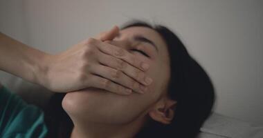 jung Frau geschlossen ihr Augen und verwenden Hand geschlossen ihr Mund während Gähnen foto