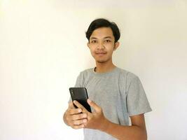 Beeindruckend und Überraschung Gesicht asiatisch Mann verwenden Smartphone mit Kopieren Raum von Werbung foto