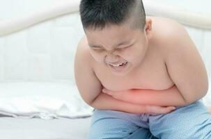 fettleibig Fett Junge Leiden von Magenschmerzen foto