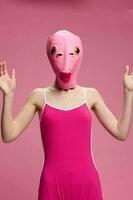 sehr seltsam Frau im ein Rosa Silikon Fisch Maske zum Halloween, verrückt Bild im Rosa Kleider foto