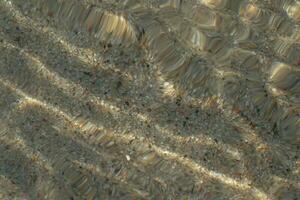abstrakt Hintergrund erstellt durch Wellen und Sand auf das Meer auf das Strand foto