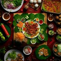oben Aussicht von Tabelle Abendessen Vietnamesisch. Knolling Fotografie von Familie Abendessen Neu Jahr , beschwingt. Vietnamesisch traditionell Mahlzeit im Land Seite. eben legen. foto