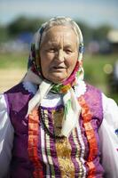 08 29 2020 Weißrussland, lyakhovichi. Stadt Festival. alt slawisch Frau im National Kleid. Russisch Oma im ein Schal. foto