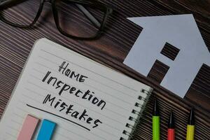 Zuhause Inspektion Fehler Text schreiben auf ein Buch isoliert hölzern Tisch. foto