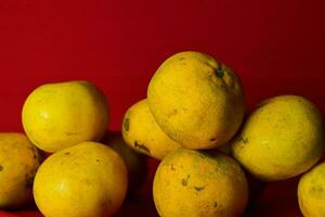 frisch Orange Obst im das rot Hintergrund foto