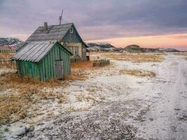 authentisch Russisch Nord Dorf, alt baufällig hölzern Häuser, hart Arktis Natur. foto